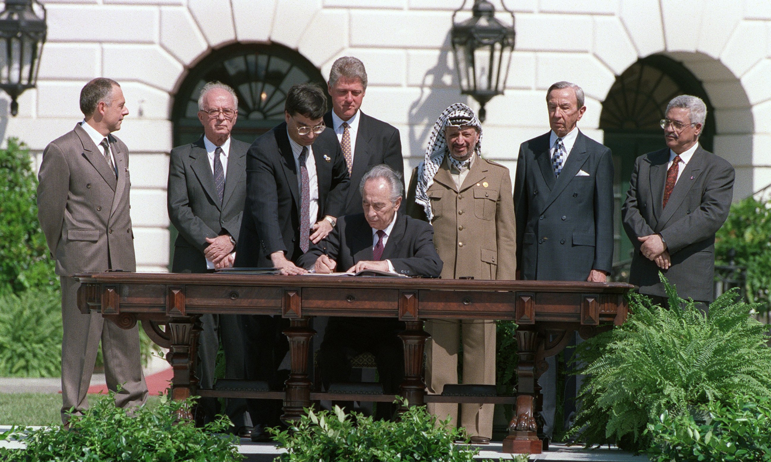 PHOTO: Israeli Foreign Minister Shimon Peres signs the agreement on Palestinian autonomy in the occupied territories on September 13, 1993 during a ceremony at the White House.  This agreement came after months of secret talks in Oslo, Norway.