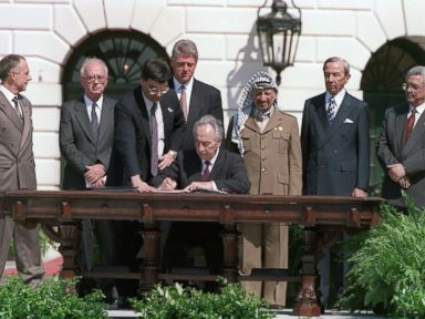 PHOTO: Israeli Foreign Minister Shimon Peres signs the agreement on Palestinian autonomy in the occupied territories on September 13, 1993 during a ceremony at the White House. This agreement came after months of secret talks in Oslo, Norway.