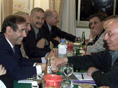 PHOTO: Israeli Foreign Minister Shlomo Ben Ami, left, shakes hands with Palestinian legislative council speaker Ahmed Qorei at the start of the marathon talks between the two sides January 21, 2001 in the Egyptian Red Sea resort of Taba.