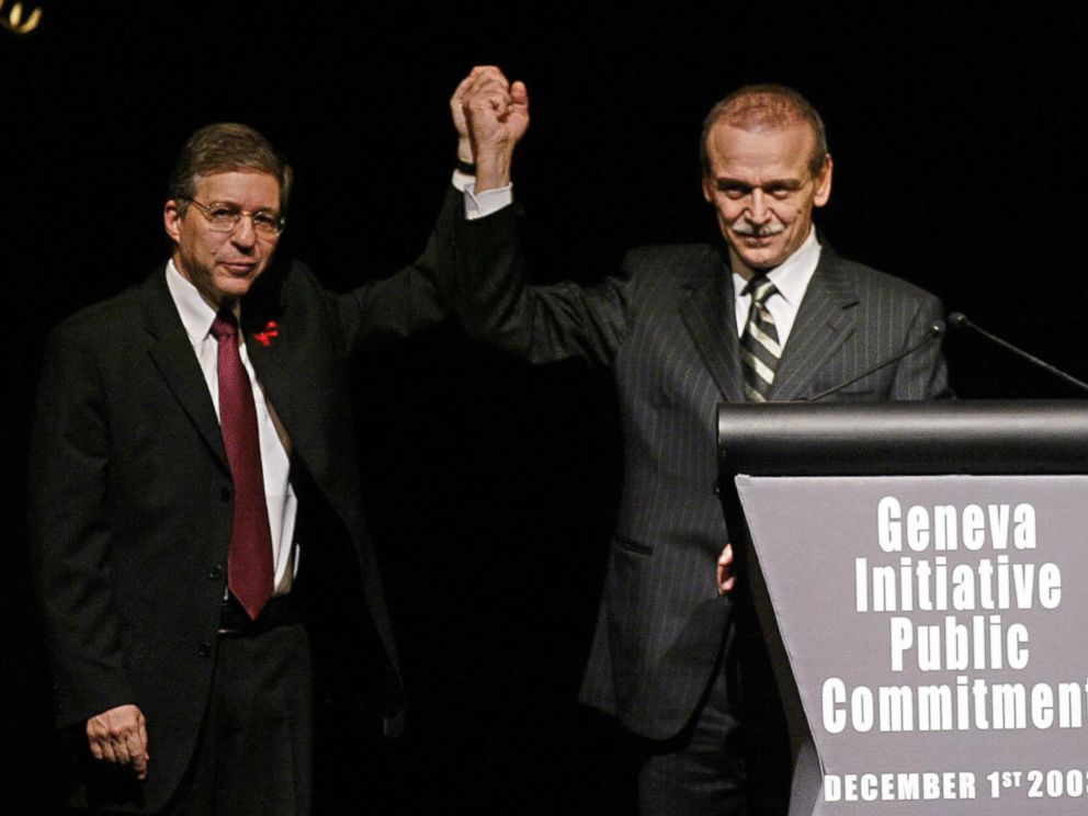 PHOTO: Former Israeli Justice Minister Yossi Beilin, left, and former Palestinian Information Minister Yasser Abed Rabbo celebrate the launching ceremony of the alternative Middle East plan at the Intercontinental hotel in Geneva, Dec. 1, 2003. 