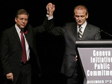PHOTO: Former Israeli Justice Minister Yossi Beilin, left, and former Palestinian Information Minister Yasser Abed Rabbo celebrate the launching ceremony of the alternative Middle East plan at the Intercontinental hotel in Geneva, Dec. 1, 2003.