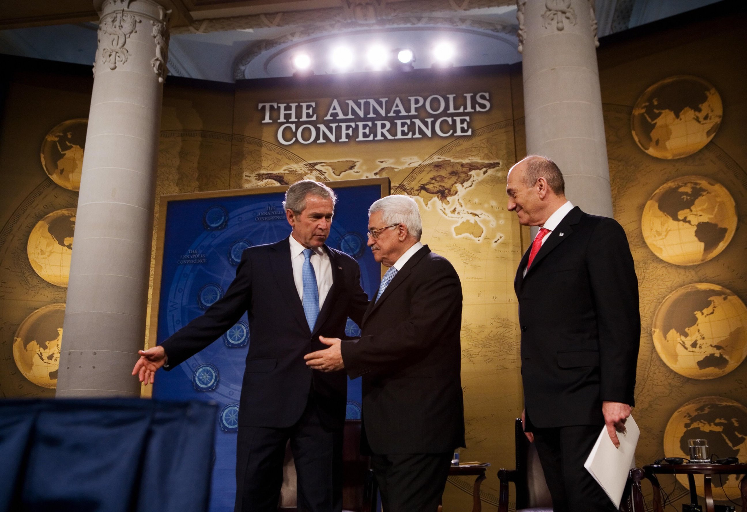 PHOTO: President George W. Bush, left, shows the way to Palestinian President Mahmud Abbas, center and Israeli Prime Minister Ehud Olmert after speaking November 27, 2007 during the Annapolis Conference at the US Naval Academy.