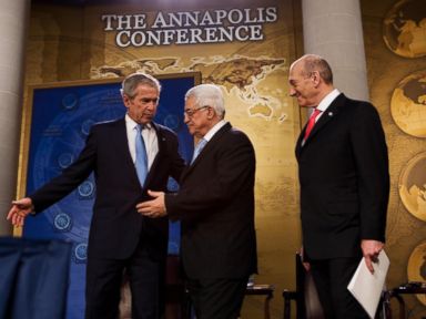 PHOTO: President George W. Bush, left, shows the way to Palestinian President Mahmud Abbas, center and Israeli Prime Minister Ehud Olmert after speaking November 27, 2007 during the Annapolis Conference at the US Naval Academy.