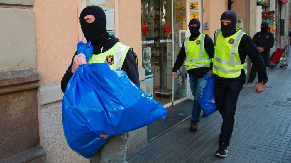Members of the Catalan Regional Police (Mossos d'Esquadra) carry  garbage bags during the raid of a flat in Barcelona, Spain, on April 25, 2017, that led to the arrest of four men accused of collaborating with the Islamic militants.



