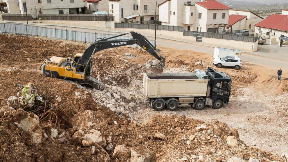 PHOTO: Palestinian labourers work at the construction site of a new housing project in the Israeli settlement of Ariel near the West Bank city of Nablus, on Jan. 25, 2017. 
