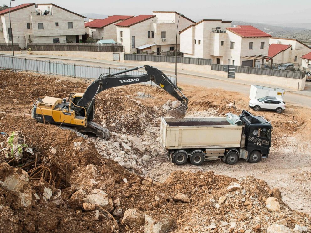 PHOTO: Palestinian labourers work at the construction site of a new housing project in the Israeli settlement of Ariel near the West Bank city of Nablus, on Jan. 25, 2017.