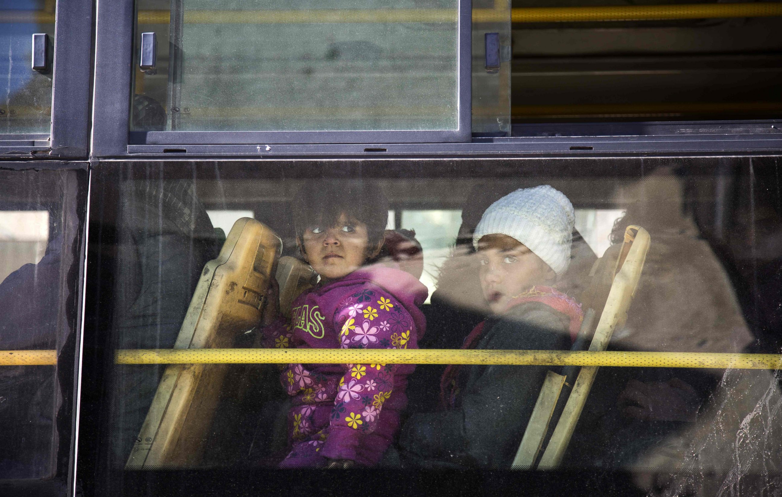 PHOTO: Children are seen inside a bus during an evacuation operation of rebel fighters and their families from rebel-held neighborhoods in Aleppo, Dec. 15, 2016.