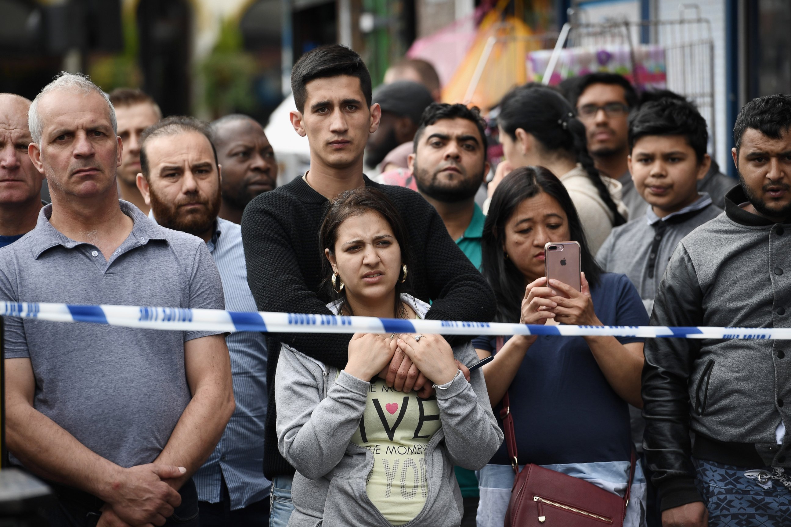 PHOTO: Members of the public view the scene after police officers raided a property in East Ham, June 4, 2017 in London, England.