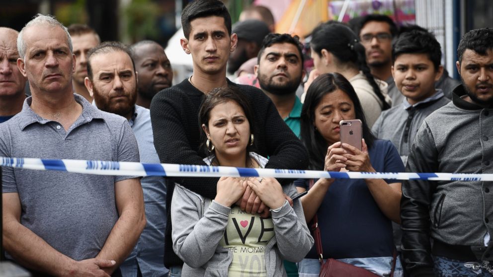 Members of the public view the scene after police officers raided a property in East Ham, June 4, 2017 in London, England.
