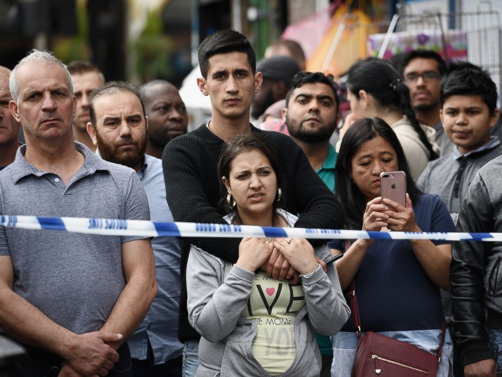 PHOTO: Members of the public view the scene after police officers raided a property in East Ham, June 4, 2017 in London, England.