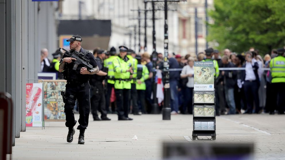 Crowds of people wait outside after police evacuated the Arndale Centre, May 23, 2017, in Manchester, England.