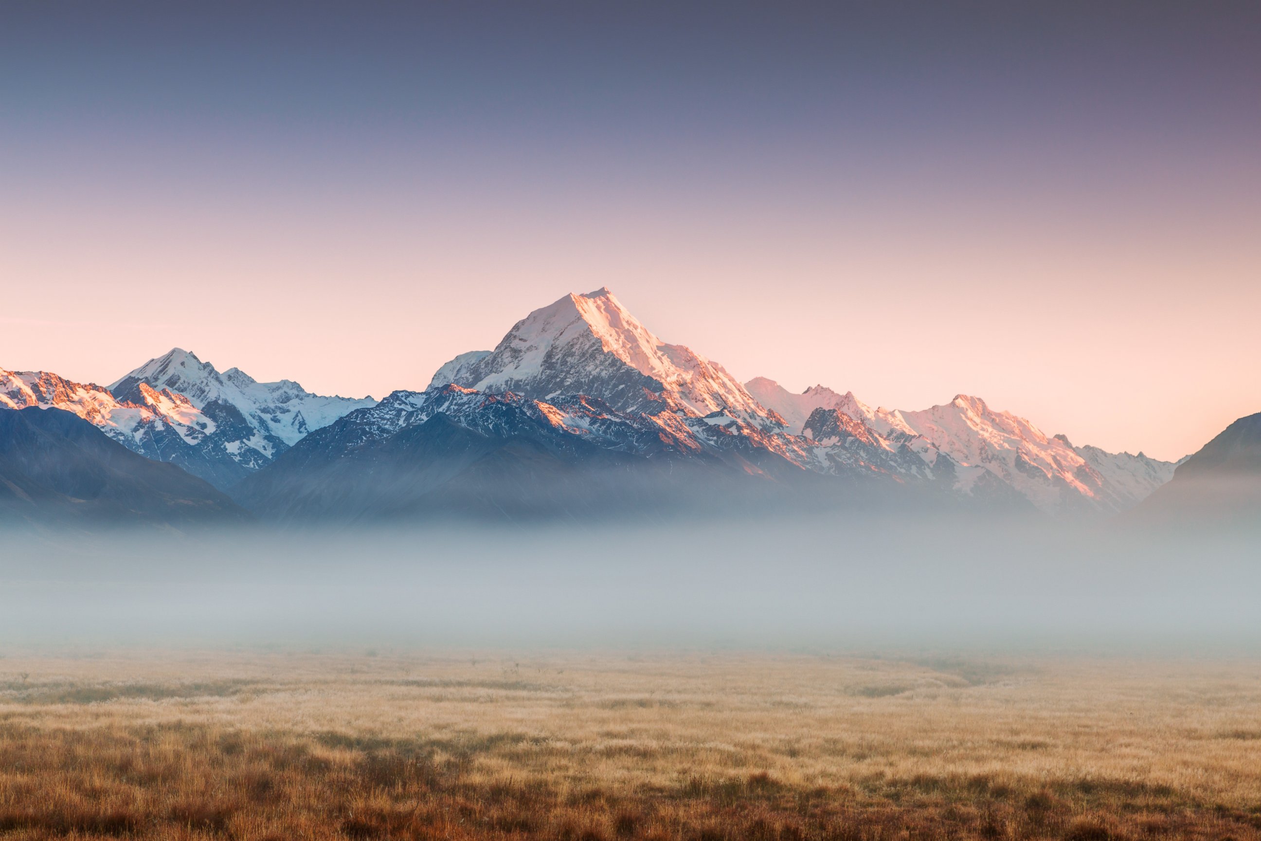 PHOTO: Mount Cook's (Aoraki) peak emerges from low mist at sunrise in Mt Cook National Park, Canterbury, South Island, New Zealand.