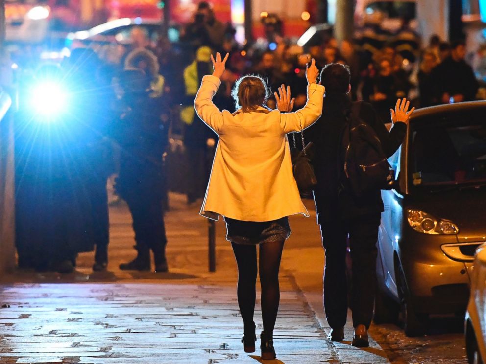PHOTO: People hold their hands up as they walk towards police officers before being controlled near the site of a shooting at the Champs Elysees in Paris on April 20, 2017.