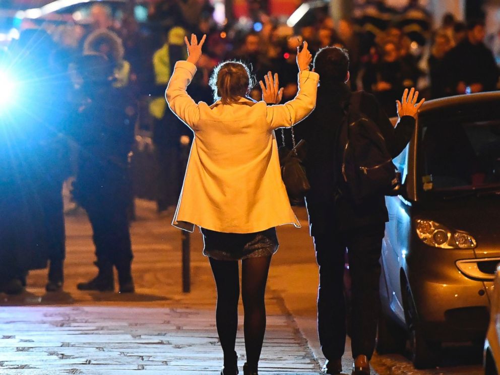 PHOTO: People hold their hands up as they walk towards police officers before being controlled near the site of a shooting at the Champs Elysees in Paris on April 20, 2017.