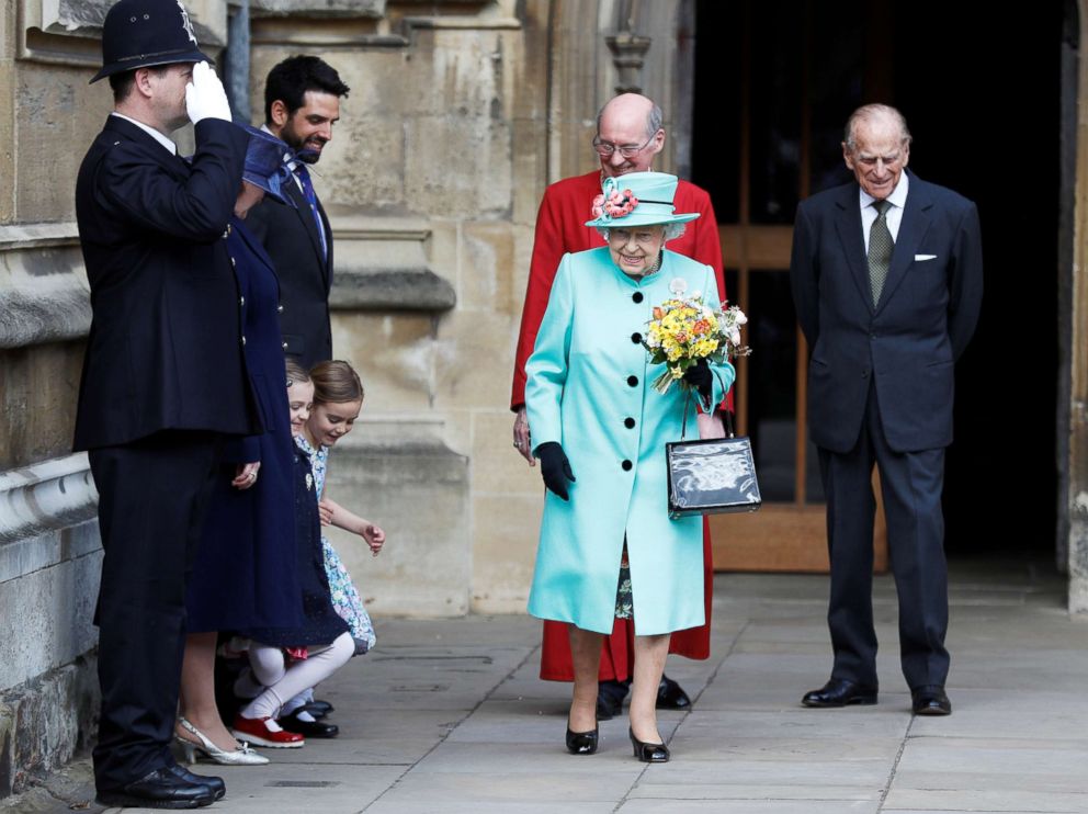 PHOTO: Girls curtsy as Queen Elizabeth II and Prince Philip, Duke of Edinburgh leave the Easter Day service at St George's Chapel, April 16, 2017, in Windsor, England.