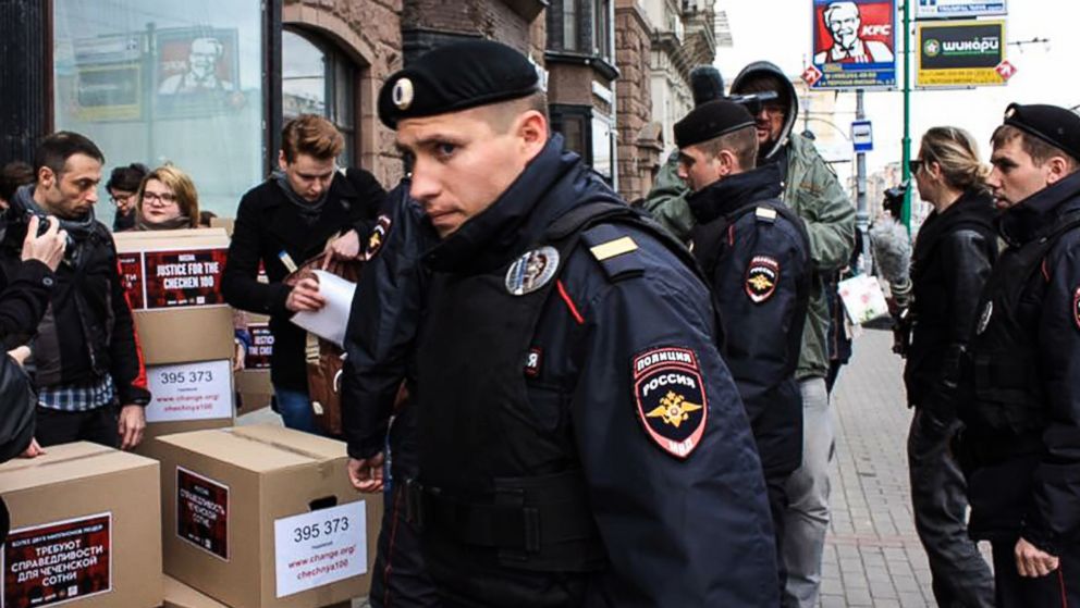 Russian policemen surround Russian gay-rights activists standing next to boxes alledgedly containing signed petitions calling for a probe into a reported crackdown on Chechnya's LGBT community, during a rally in central Moscow, May 11, 2017.



