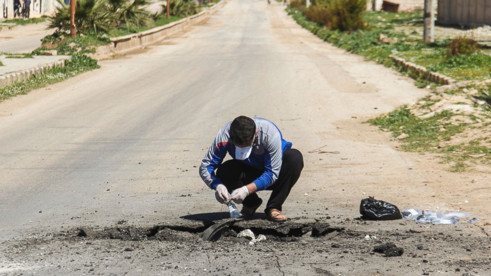 PHOTO: A Syrian man collects samples from the site of a suspected toxic gas attack in Khan Sheikhun, in Syria's Idlib province, April 5, 2017.
