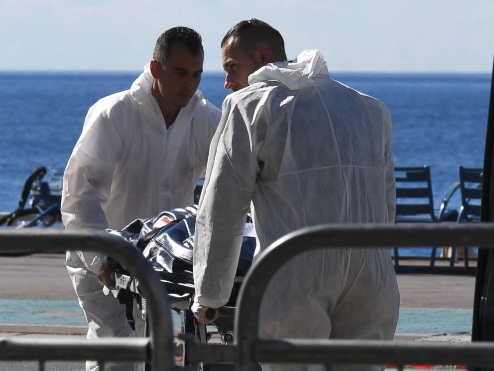 PHOTO: Forensics experts evacuate a dead body on the Promenade des Anglais seafront in the French Riviera town of Nice on July 15, 2016, after a gunman smashed a truck into a crowd of revelers celebrating Bastille Day.