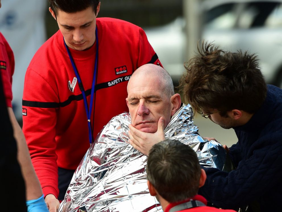 PHOTO: A victim receives first aid by rescuers, March 22, 2016 near Maalbeek metro station in Brussels, after a blast at this station near the EU institutions caused deaths and injuries.