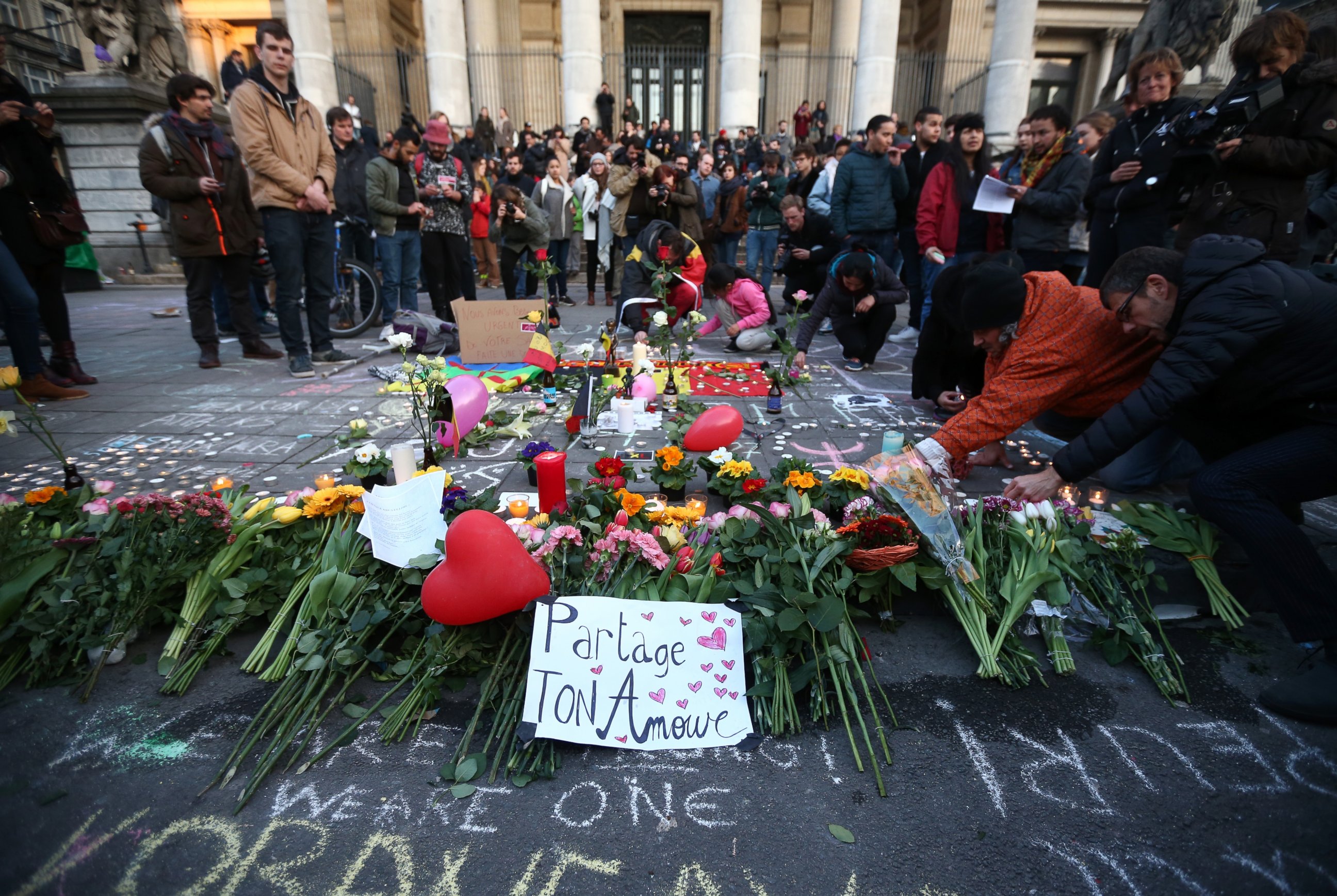PHOTO: People gather to leave tributes at the Place de la Bourse following today's attacks, March 22, 2016 in Brussels.