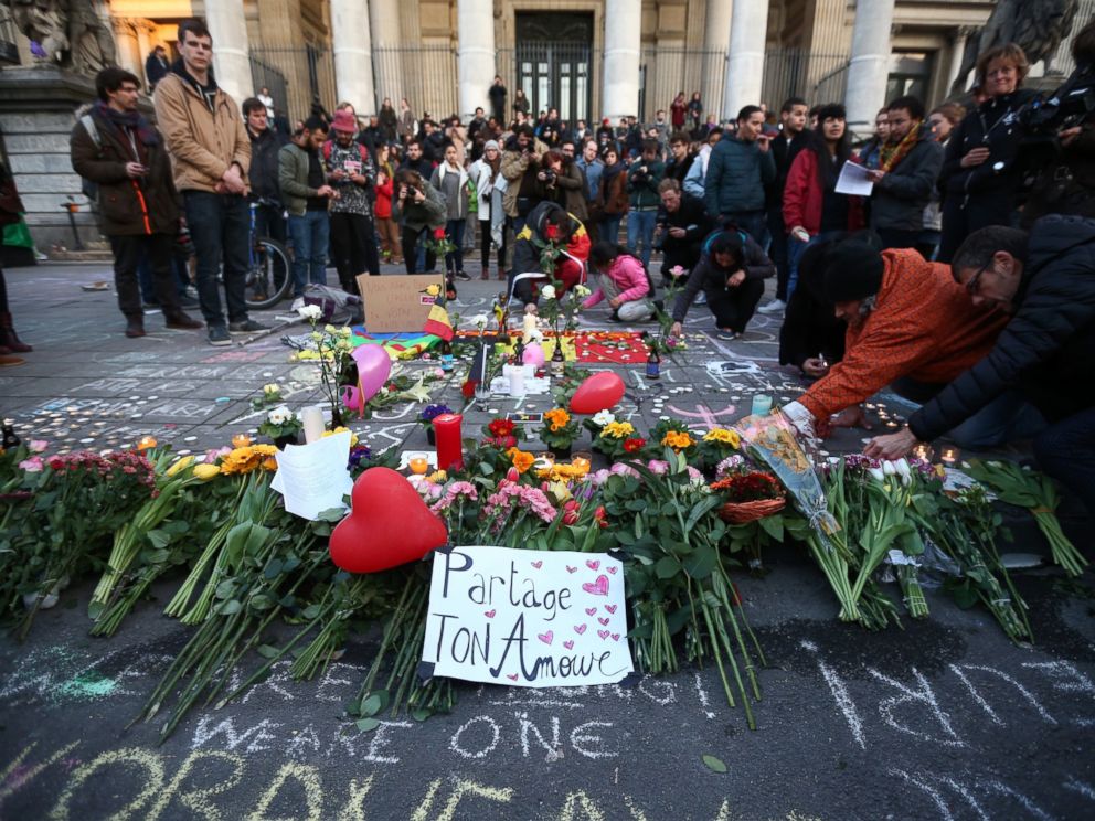 PHOTO: People gather to leave tributes at the Place de la Bourse following todays attacks, March 22, 2016 in Brussels.