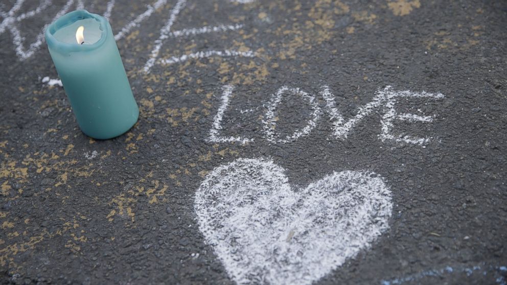 PHOTO: A candle burns next to a heart drawing at a makeshift memorial at Place de la Bourse following attacks in Brussels, March 22, 2016. 