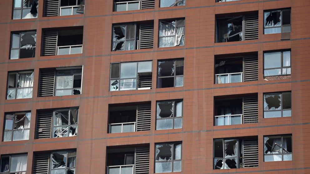 PHOTO: Shattered windows are seen on the facade of a residential building near the site of a series of explosions in Tianjin, China on Aug. 13, 2015. 