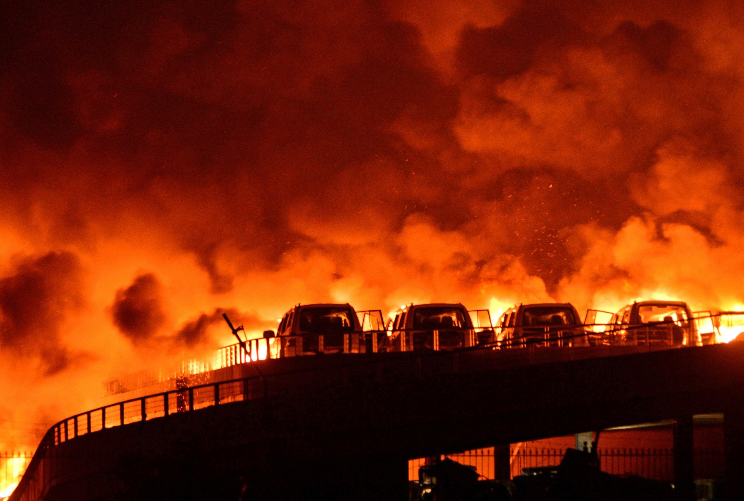 PHOTO: Fire and smoke are seen after explosions at a warehouse in Binhai New Area on Aug. 13, 2015 in Tianjin, China. 