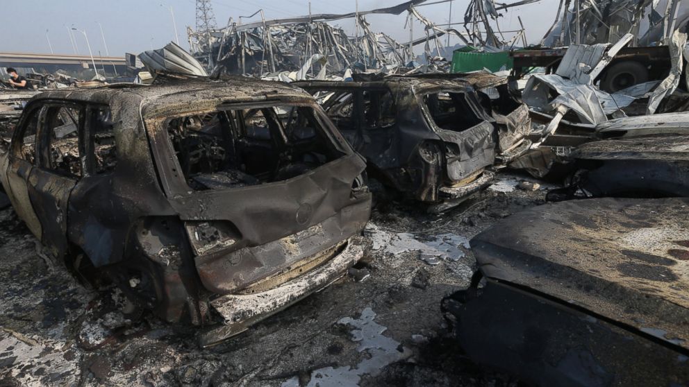 PHOTO: Burnt cars are seen in the debris following the explosions of a warehouse in Binhai New Area on Aug. 13, 2015 in Tianjin, China. 