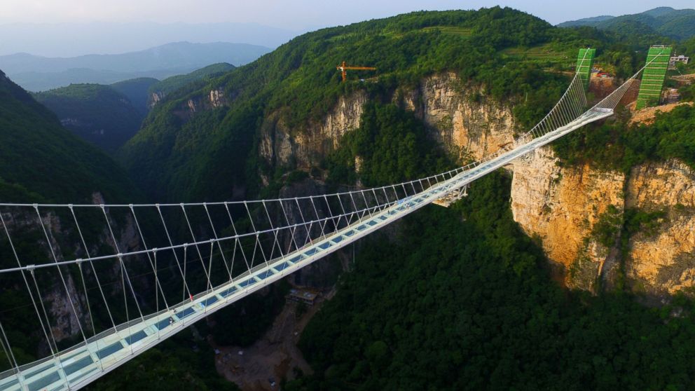 The world's longest and highest glass-bottomed bridge stretches across the Zhangjiajie Grand Canyon in Zhangjiajie, Hunan Province of China, on June 12, 2016. 