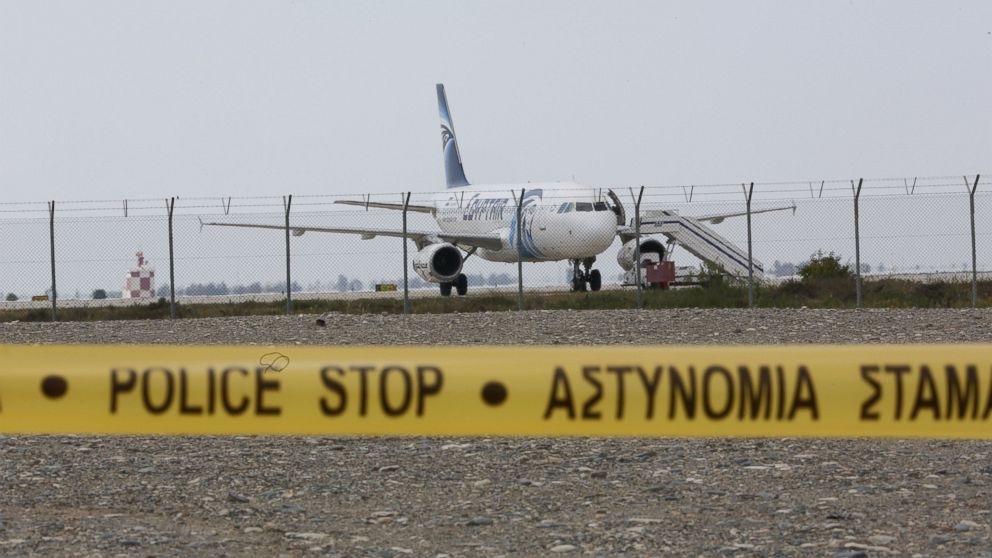 PHOTO:Cypriot security forces cordon off the area around Larnaca airport where an EgyptAir Airbus A-320 is seen on the tarmac after being hijacked and diverted to Cyprus, March 29, 2016. 