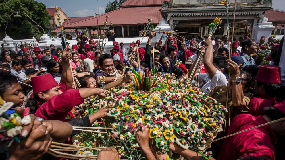 PHOTO: Javanese people arrange the 'Gunungan' during Grebeg Syawal ceremony in front of the Grand Mosque Kauman on July 18, 2015 in Yogyakarta, Indonesia. Grebeg Syawal is a tradition that follows the holy month of Ramadan to welcome Eid Al-Fitr. 