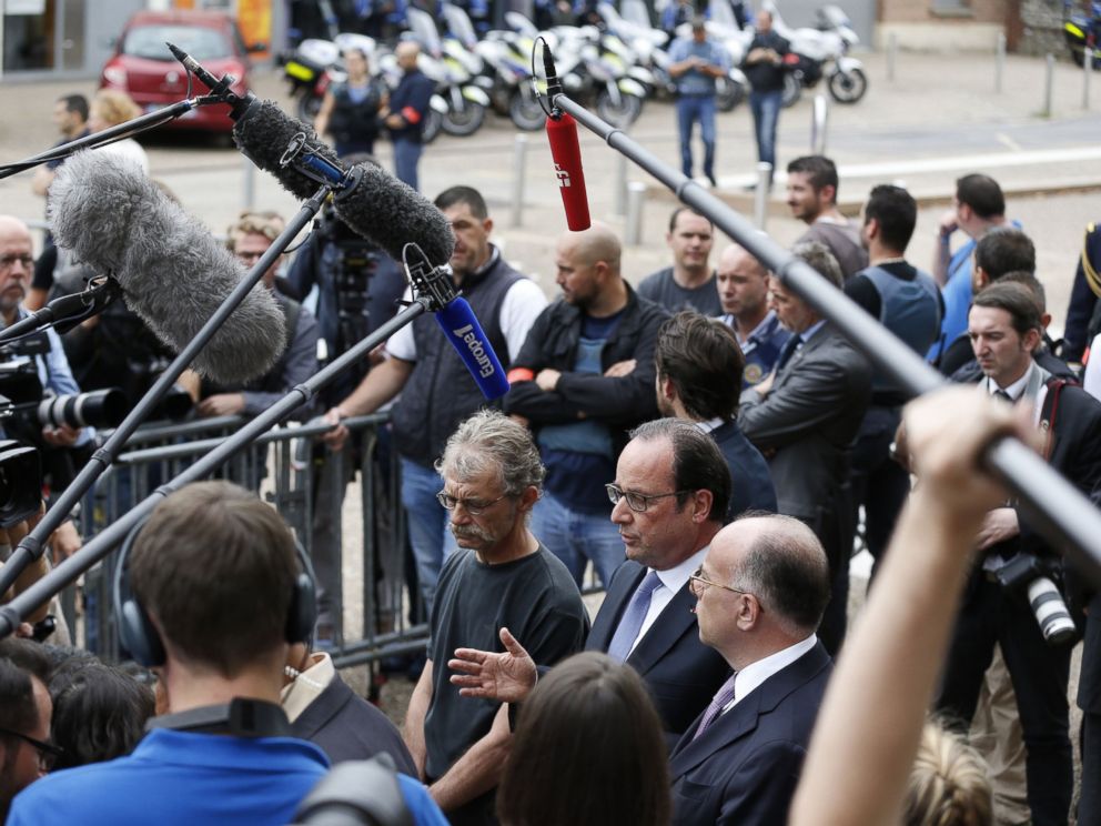 PHOTO: French President Francois Hollande speaks to the press as he leaves the Saint-Etienne-du-Rouvrays city hall following a hostage-taking at a church of the town on July 26, 2016 that left the priest dead.