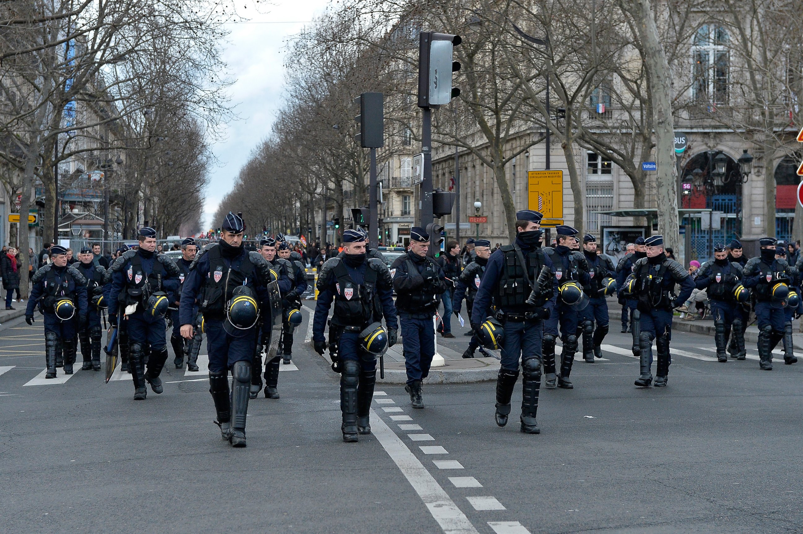PHOTO: French riot police walk in front of protestors during the demonstration against labour reforms on March 9, 2016 in Paris, France.