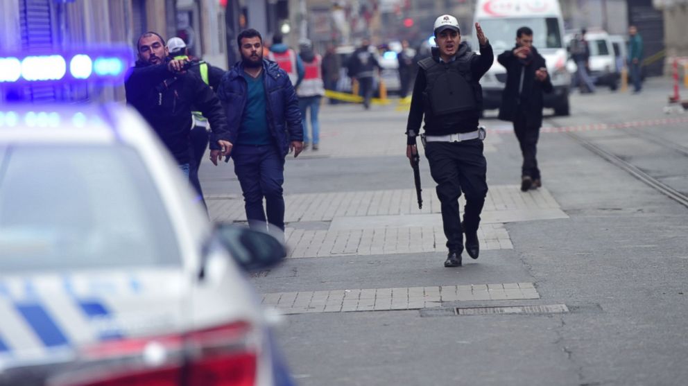 Turkish police push people away just after an explosion on the pedestrian Istiklal avenue in Istanbul, March 19, 2016.