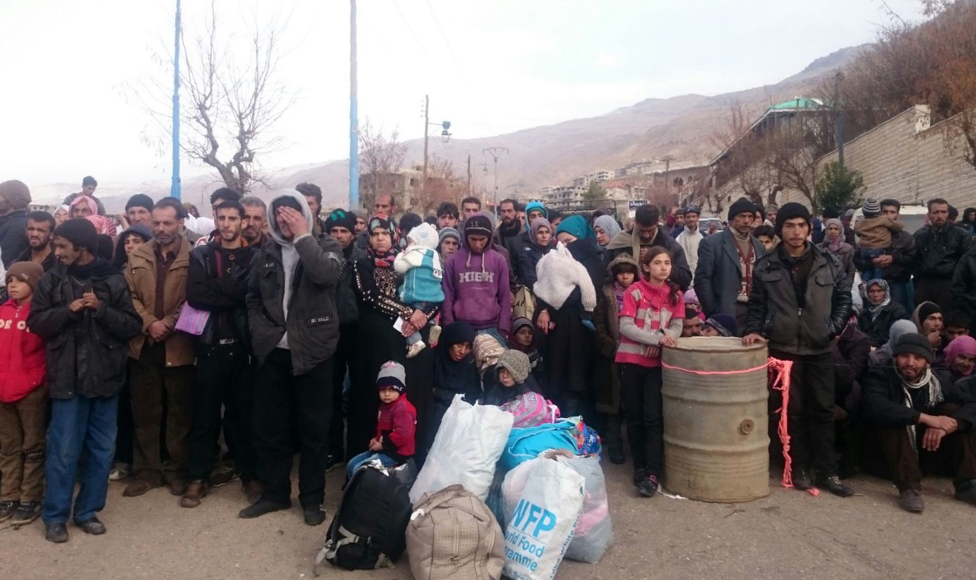 PHOTO:Syrians wait for the arrival of an aid convoy in the besieged town of Madaya, Jan. 11, 2016. 