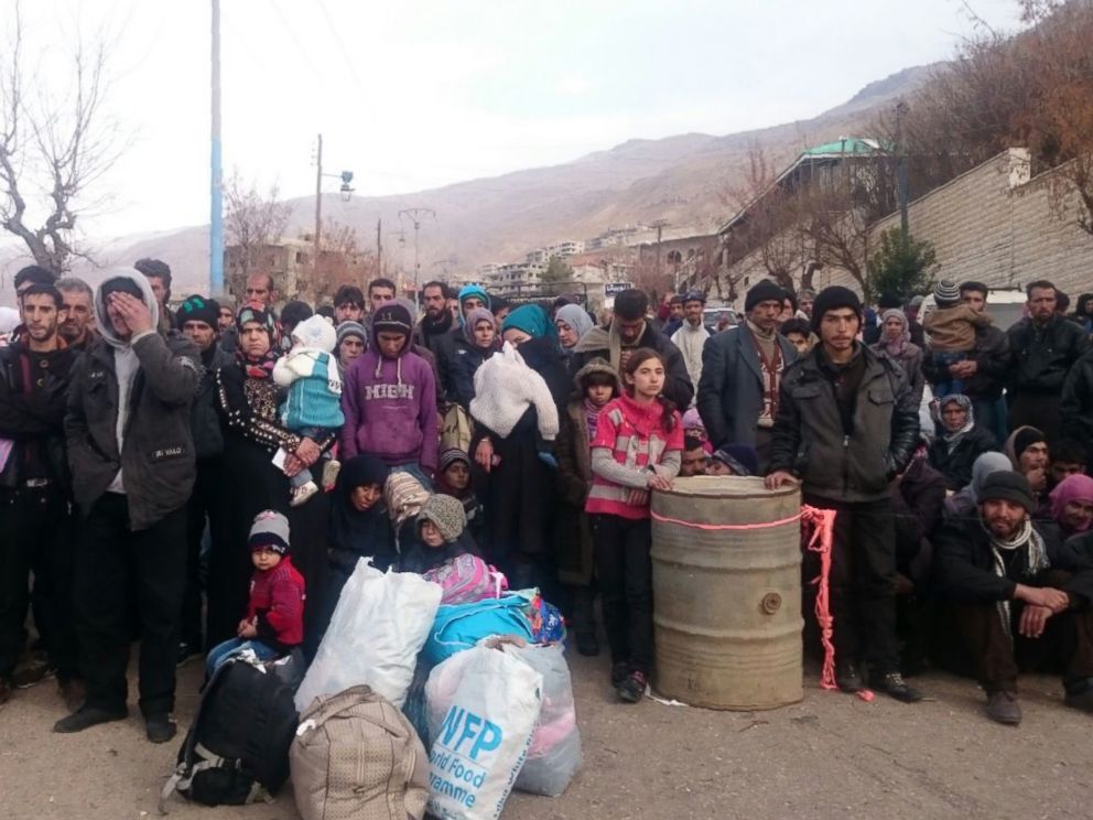 PHOTO:Syrians wait for the arrival of an aid convoy in the besieged town of Madaya, Jan. 11, 2016.