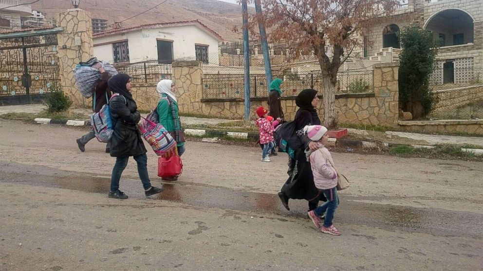 PHOTO:Syrians carry their belongings as they leave the besieged rebel-held Syrian town of Madaya, Jan. 11, 2016. 