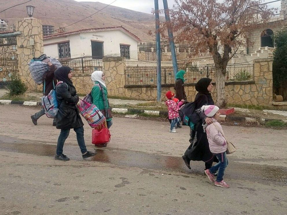 PHOTO:Syrians carry their belongings as they leave the besieged rebel-held Syrian town of Madaya, Jan. 11, 2016.