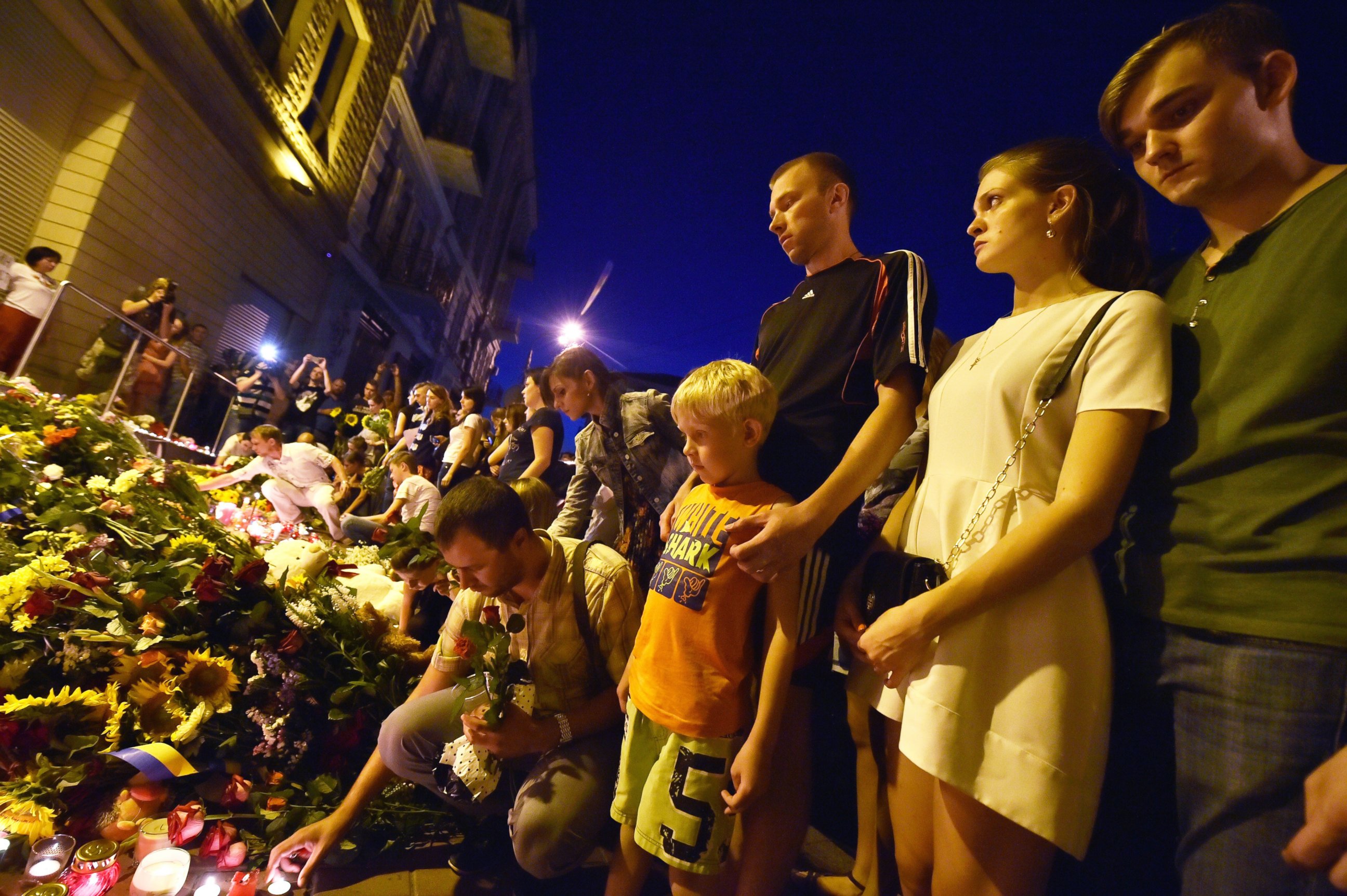 PHOTO: People lay flowers and light candles in front of the Embassy of the Netherlands in Kiev on July 17, 2014, to commemorate passengers of Malaysian Airlines flight MH17 from Amsterdam to Kuala Lumpur which crashed in eastern Ukraine.