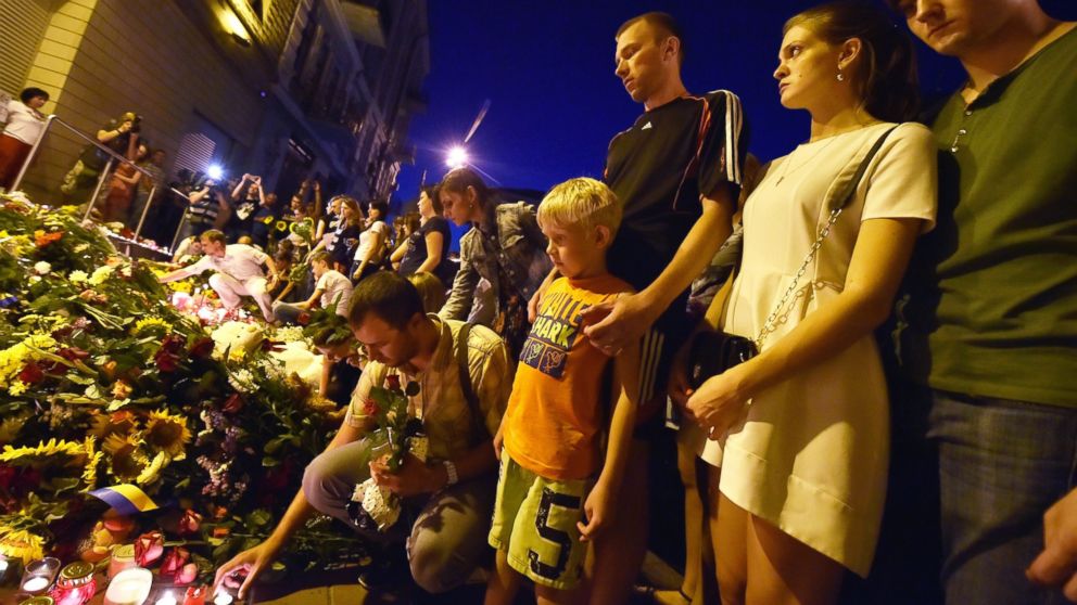 PHOTO: People lay flowers and light candles in front of the Embassy of the Netherlands in Kiev on July 17, 2014, to commemorate passengers of Malaysian Airlines flight MH17 from Amsterdam to Kuala Lumpur which crashed in eastern Ukraine.
