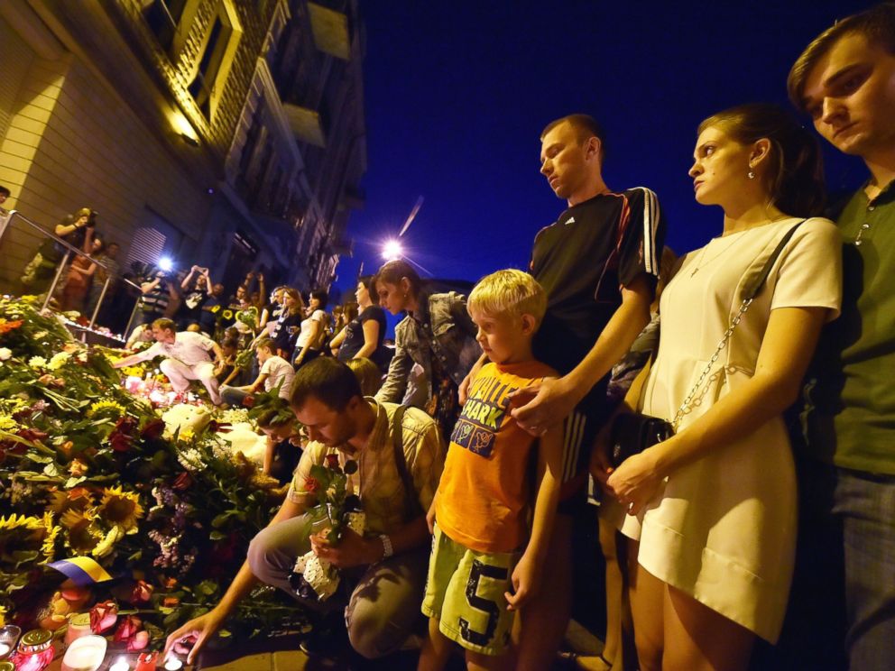 PHOTO: People lay flowers and light candles in front of the Embassy of the Netherlands in Kiev on July 17, 2014, to commemorate passengers of Malaysian Airlines flight MH17 from Amsterdam to Kuala Lumpur which crashed in eastern Ukraine.