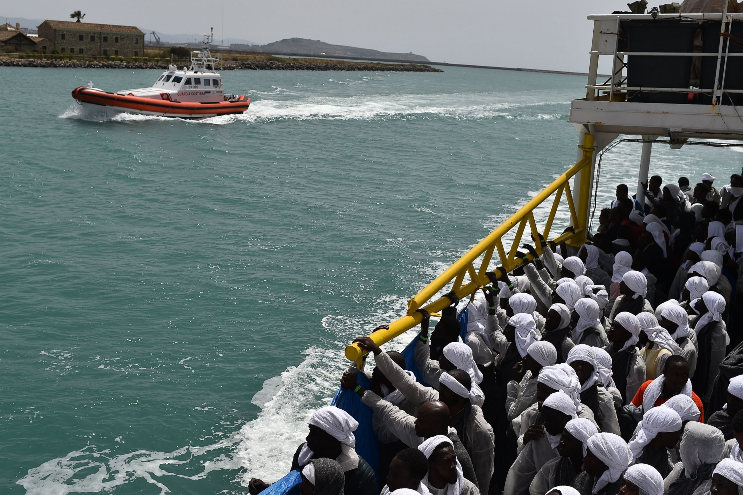 PHOTO: Migrants arrive in the port of Cagliari, Sardinia, aboard rescue ship "Aquarius", on May 26, 2016, two days after being rescued near the Libyan coasts. 