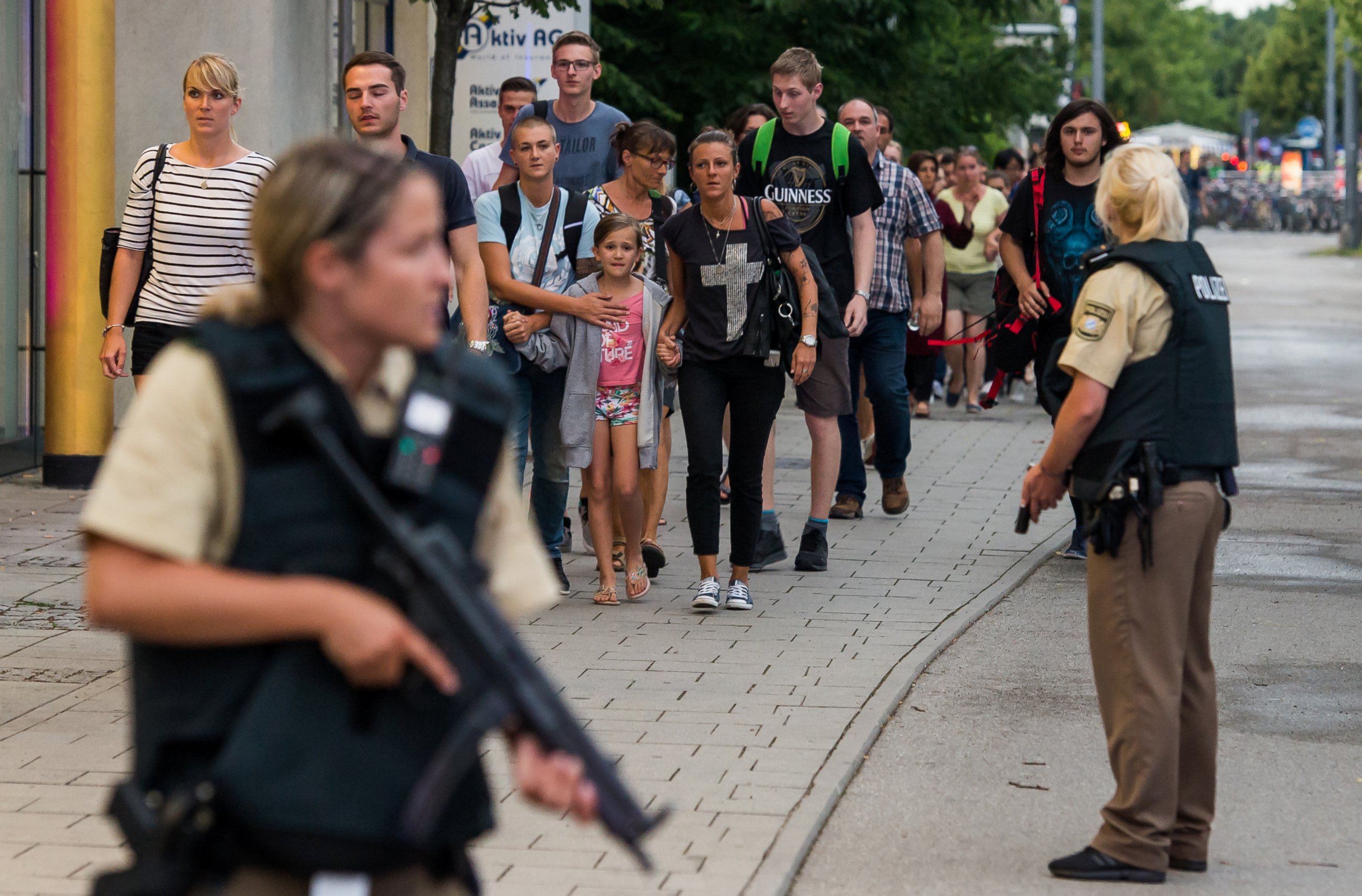 PHOTO: Police officers escort people from inside the shopping center as they respond to a shooting at the Olympia Einkaufzentrum on  July 22, 2016 in Munich.