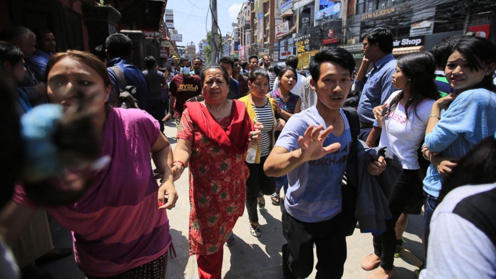 People run in the street after a magnitude 7.3 earthquake hit Nepal, in Kathmandu, Nepal, on May 12, 2015.