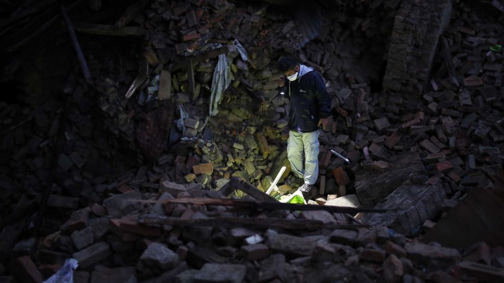 PHOTO: A member of IHH Humanitarian Relief Foundation attends a rescue operation among the debris of a house after a powerful earthquake hits Bhaktapur, Nepal on April 27, 2015.