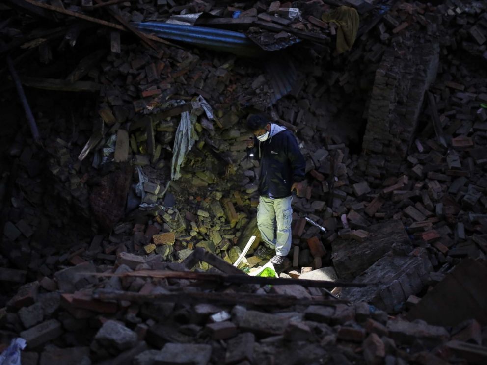 PHOTO: A member of IHH Humanitarian Relief Foundation attends a rescue operation among the debris of a house after a powerful earthquake hits Bhaktapur, Nepal on April 27, 2015.