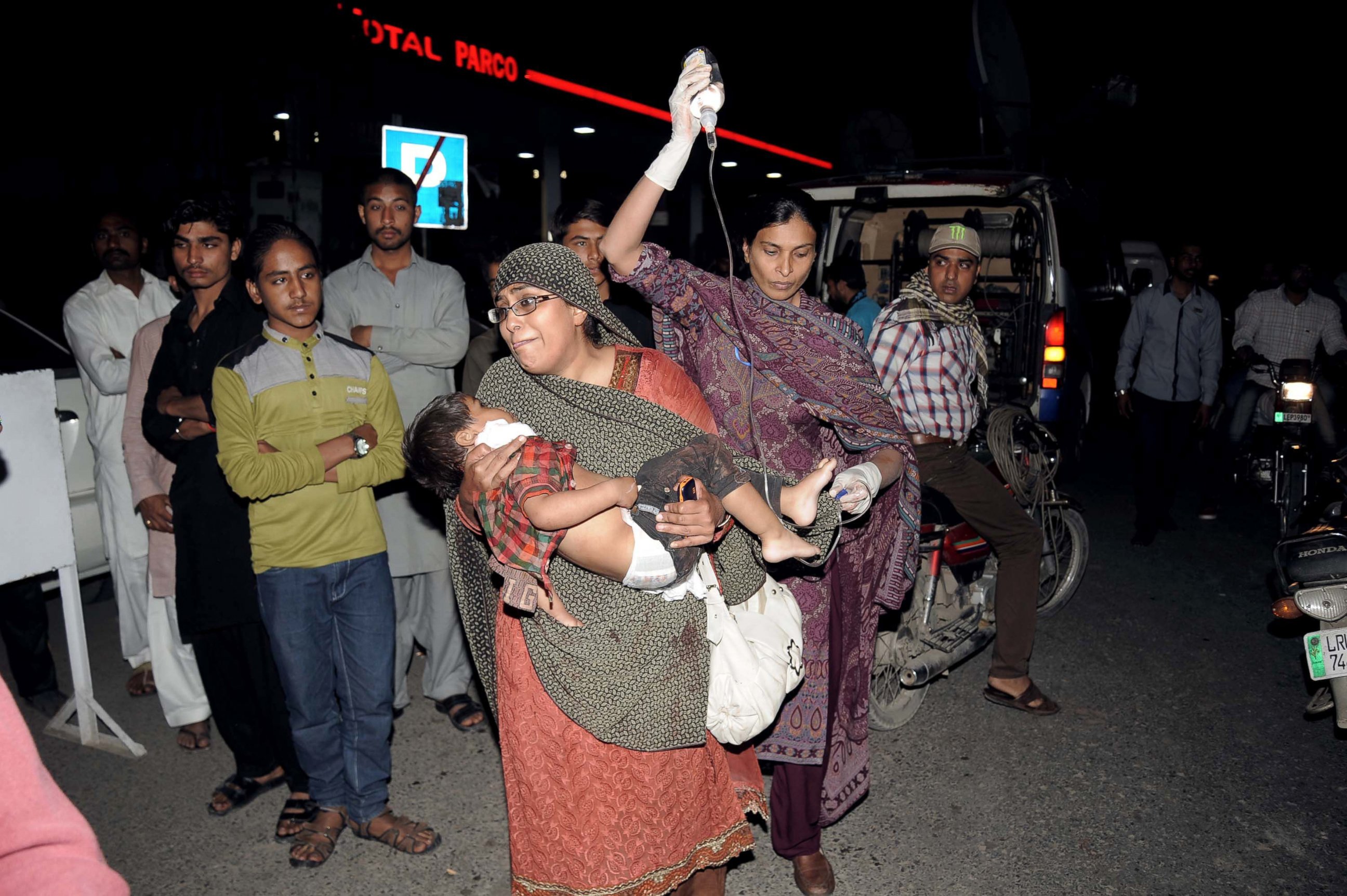 PHOTO: Pakistani relatives bring an injured child to the hospital in Lahore, on March 27, 2016, when an apparent suicide bomb ripped through the parking lot of a crowded park in the Pakistani city of Lahore where Christians were celebrating Easter.
