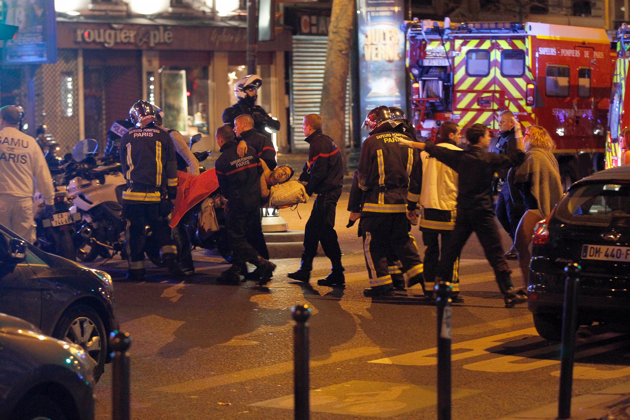PHOTO: Medics move a wounded man near the Boulevard des Filles-du-Calvaire after an attack November 13, 2013 in Paris, France. Gunfire and explosions in multiple locations erupted in the French capital with early casualty reports indicating many dead. 