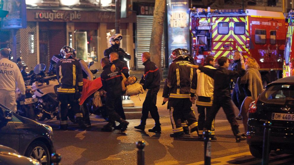 PHOTO: Medics move a wounded man near the Boulevard des Filles-du-Calvaire after an attack November 13, 2013 in Paris, France. Gunfire and explosions in multiple locations erupted in the French capital with early casualty reports indicating many dead. 